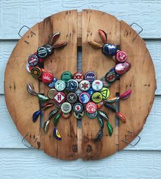 a wooden circle with many different bottle caps on it