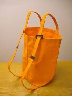 an orange bag sitting on top of a wooden table