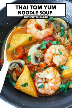 thai noodle soup with shrimp and vegetables in a black bowl