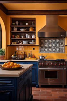 a kitchen with oranges on the counter and an oven in the center, surrounded by blue cabinets