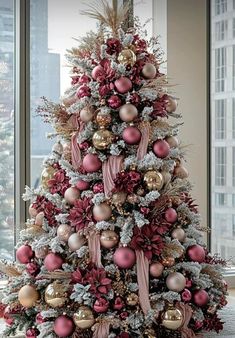 a christmas tree decorated with pink and gold ornaments