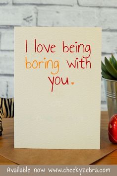 a card with the words i love being boring with you next to a toy zebra