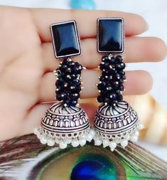 Add a touch of elegance to your bridal or party look with this stunning pair of oxidised earrings from My Jewel Box. The intricate design showcases natural pearls and stones in multiple colours, making it perfect for any occasion including engagement, wedding, anniversary, birthday or Valentine's Day. The excellent cut grade of the stones ensures maximum sparkle and glamour. Crafted from high-quality alloy and designed in Pakistan, these earrings are not only fashionable but also durable. The In Festive Oxidized Finish Jhumkas For Celebration, Silver Stone Work Danglers For Eid, Bollywood Oxidized Finish Jhumkas For Wedding, Bollywood Style Oxidized Jhumkas For Festive Occasion, Silver Danglers With Stone Work For Eid, Oxidized Finish Earrings For Wedding And Diwali, Oxidized Jhumkas For Wedding And Navratri, Bollywood Oxidized Jhumkas For Wedding, Bollywood Wedding Jhumkas With Oxidized Finish