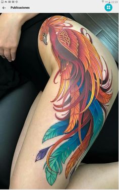 a woman's thigh with a colorful tattoo on it and an image of a bird