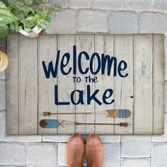 a welcome mat with an arrow and the words welcome to the lake