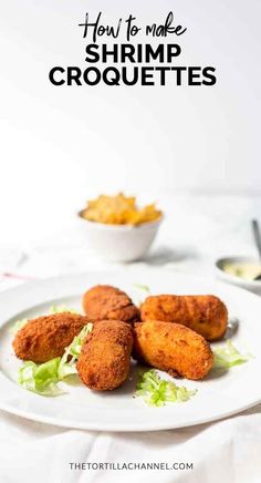 fried shrimp croquettes on a white plate with lettuce and mustard