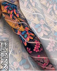 an arm tattoo with flowers and fish on it