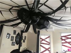 the ceiling fan is decorated with black ribbons