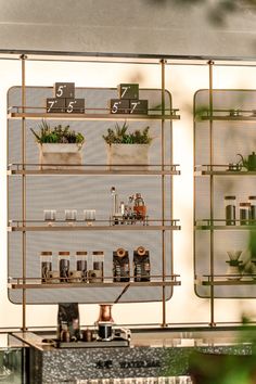 the shelves are filled with plants and bottles on them, along with numbers to indicate where each shelf is located