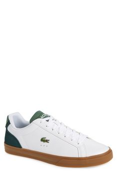 An embroidered crocodile and bold logos define a low-top sneaker made with a smooth leather upper that sits atop a grippy rubber sole. Lace-up vamp Leather and textile upper/textile lining/rubber sole Imported Casual Green Sneakers With Embossed Logo, Casual Tennis Sneakers With Textured Sole, Sneaker Men, Mens Shoes Sneakers, Smooth Leather, Low Top, Nordstrom Rack, Top Sneakers, Rubber Sole