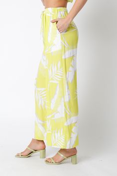 Introducing our luxurious Lemon and Lime Beach Pant, perfect for any tropical escape. Featuring convenient pockets, a flattering drawstring tie waist, and a wide leg design, these pants are both stylish and functional. The vibrant lime color and tropical print add a touch of sophistication to any outfit. Embrace the beauty of paradise with these elegant beach pants. Tropical Escape, Beach Pants, Pants Large, Shoe Gifts, Tropical Print, New Arrival Dress, Mommy And Me, Jacket Tops, Lemon