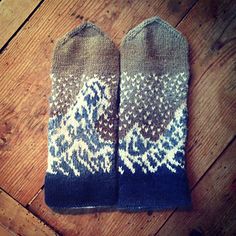 two pairs of blue and white socks sitting on top of a wooden floor