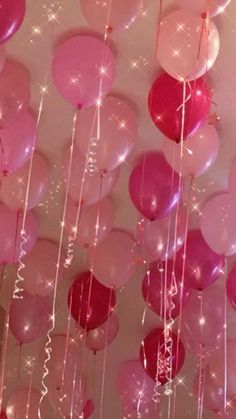 pink and red balloons hanging from the ceiling