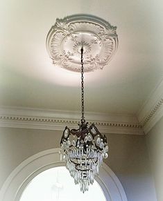 an ornate chandelier hangs from the ceiling