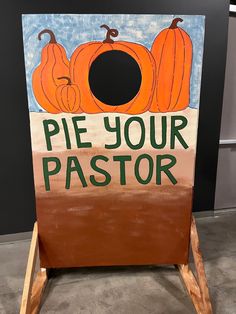 a wooden sign that says pie your pastor with pumpkins on the front and bottom