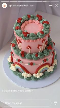 a three tiered cake with red and green frosting on the top, sitting on a plate