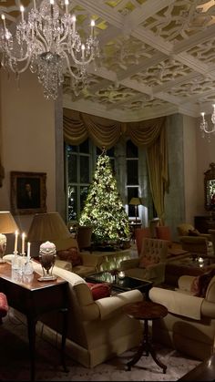 a living room filled with furniture and a christmas tree in the middle of the room