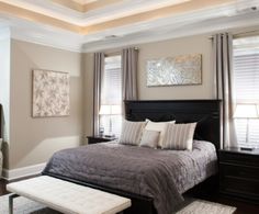 a bedroom with a large bed and two windows in the ceiling, along with a rug on the floor