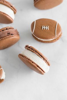 chocolate covered cookies with white frosting and footballs on them are arranged in the shape of balls