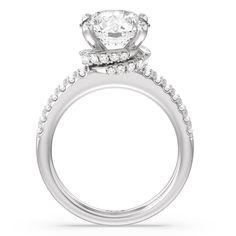 a white gold engagement ring with two rows of diamonds on the band and an oval shaped center