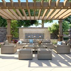 an outdoor living area with blue cushions and wicker furniture under a pergolated roof