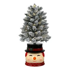 a small christmas tree with a snowman hat on it's head and nose