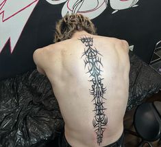 a man with a tattoo on his back