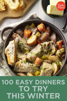 a pan filled with chicken and vegetables next to bread