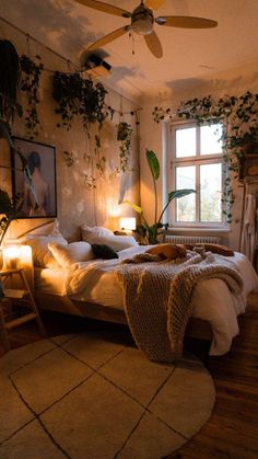 a bed room with a neatly made bed next to a window and a ceiling fan