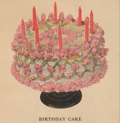 an old birthday cake with pink flowers and lit candles on it's top is shown