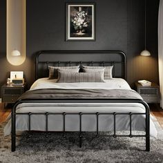 a black and white bedroom with a bed, nightstands, lamps and pictures on the wall