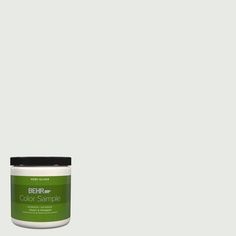 a green paint can with the words behre color sample on it and an image of