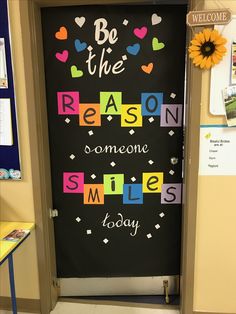 a classroom door decorated with the words be the reason someone smiles today and sunflowers