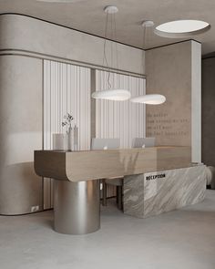 a modern office with marble counter tops and white walls, along with round lights hanging from the ceiling