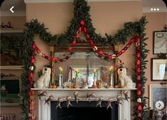 a fireplace decorated for christmas with candles and decorations