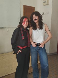 two women standing next to each other with painted faces