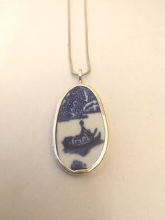 Broken China Jewelry Broken China Pendant Broken China Necklace    Broken China Jewelry, Pendant. Sterling Silver, "BLUE WILLOW BOAT" 1 15/16" Inches Long   15/16" Inches Wide  Every piece of broken china is unique and carefully handcrafted . Each piece is stamped with the artists name. All pieces are bezelled in fine silver. Bail and backing are Sterling silver . Broken Pottery Jewelry, Pottery Jewelry, Broken China Jewelry, China Jewelry, Broken China, Meaningful Jewelry, Blue Willow, China Patterns, Delicate Details