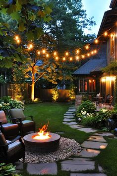 a fire pit in the middle of a yard surrounded by lawn furniture and string lights