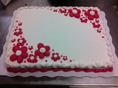 a white and red cake with flowers on it