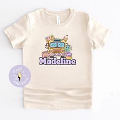 Our Kids First Day of School Shirt is perfect for your little one's first day. This Girls Custom Name Back to School Tshirt completes the perfect 1st Day of School Outfit. Make her first day extra special with a Girls Personalized 1st Day of School Shirt that celebrates her individuality. 📝HOW TO ORDER📝 ✅ Select Color ✅ Select Select Size  ✅ Enter child's name in the personalization box. Name will be printed EXACTLY as entered. If you type the name in all caps, that is how it will be printed. Please double-check spelling! 🌈 COLORS 🌈 ✨ White ✨ Natural ✨ Pink * Refer to listing photos for color chart 📏 SIZES 📏 📏 2T 📏 3T 📏 4T 📏 5T 📏 Youth S (6-8) 📏 Youth M (10-12) 📏 Youth L (14-16) 📏 Youth XL (18-20) * Refer to listing photos for size chart ⏱ PRODUCTION ⏱ 2-3 business days (desi End Of School Year Graphic Print Tops For Playtime, Playful T-shirt For Daycare, End Of School Year Graphic Print T-shirt For Playtime, Personalized Cotton T-shirt For Playtime, Letter Print T-shirt For End Of School Year Playtime, Personalized Cute Tops For Playtime, Cute Crew Neck T-shirt For Daycare, 1st Day Of School Outfit, Kids First Day Of School