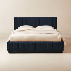 a bed with blue upholstered headboard and foot board on top of it