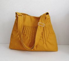 a yellow purse sitting on top of a white table