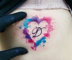 a woman's stomach with the letter d painted in watercolor on her belly