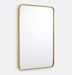 a gold framed mirror hanging on the wall