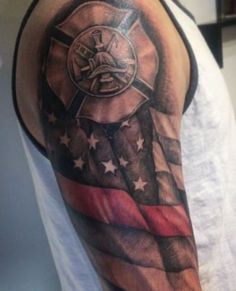 a man's arm with an american flag and cross on it