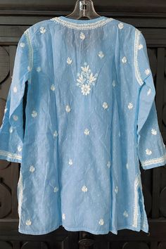 This Sky Blue Pure Cotton Lucknowi Kurta is a perfect combination of timeless elegance and traditional craftsmanship. Made with high-quality, breathable cotton fabric, this kurta top is both comfortable and stylish. The pristine white color adds a touch of purity and grace, making it a versatile choice for any occasion. Pure cotton Work: hand embroidered front, back & sleeves Length: 30" Long sleeves 18" Round neck Side slit Lined: no Chikankari embroidery Hand embroidered Hand wash, dry flat Fi Chikankari Short Kurti, Cotton Chikankari Kurta, Phulkari Pants, Lucknowi Kurta, Gharara Suits, Patiala Salwar Suits, Kurta Top, Chikankari Embroidery, Bridal Dupatta