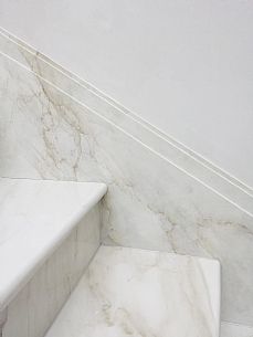 a bathroom with marble steps and white walls