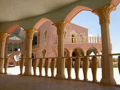 the inside of a building with columns and arches