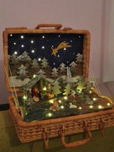 an open suitcase sitting on top of a floor covered in christmas lights and decorations,