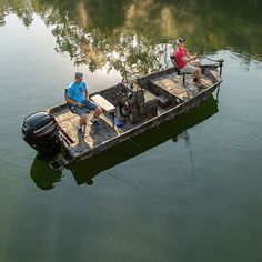 two men sitting in a small boat on the water